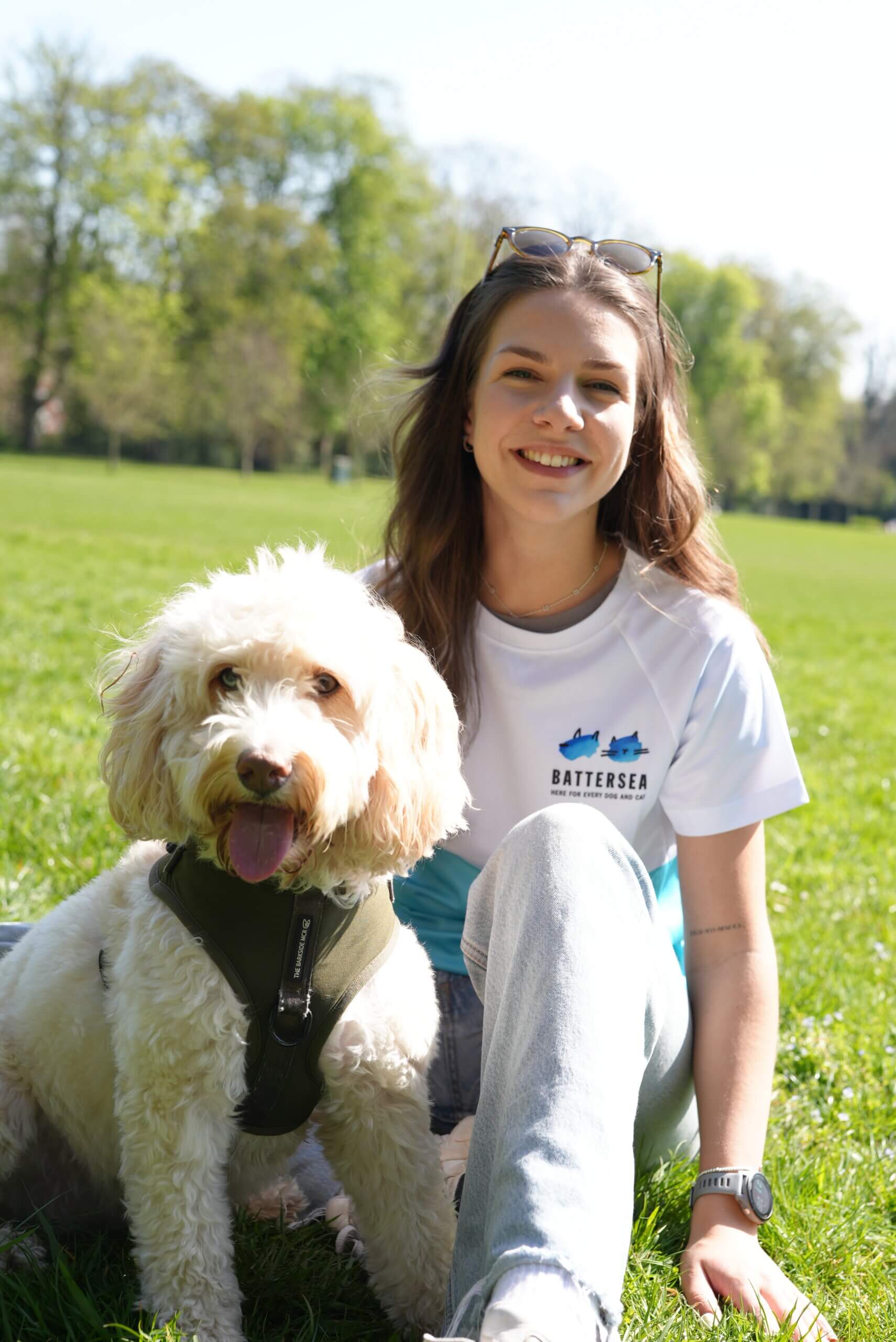 Woman sat with a white fluffy dog
