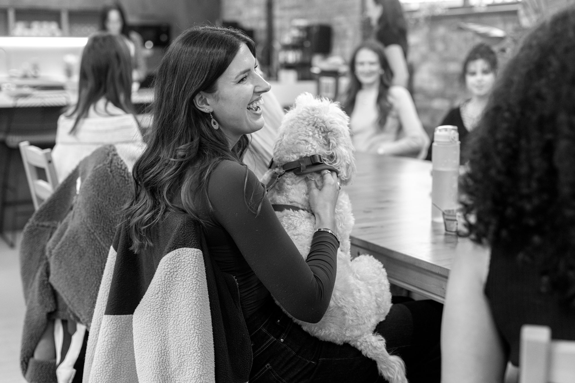 women smiling with dog on lap