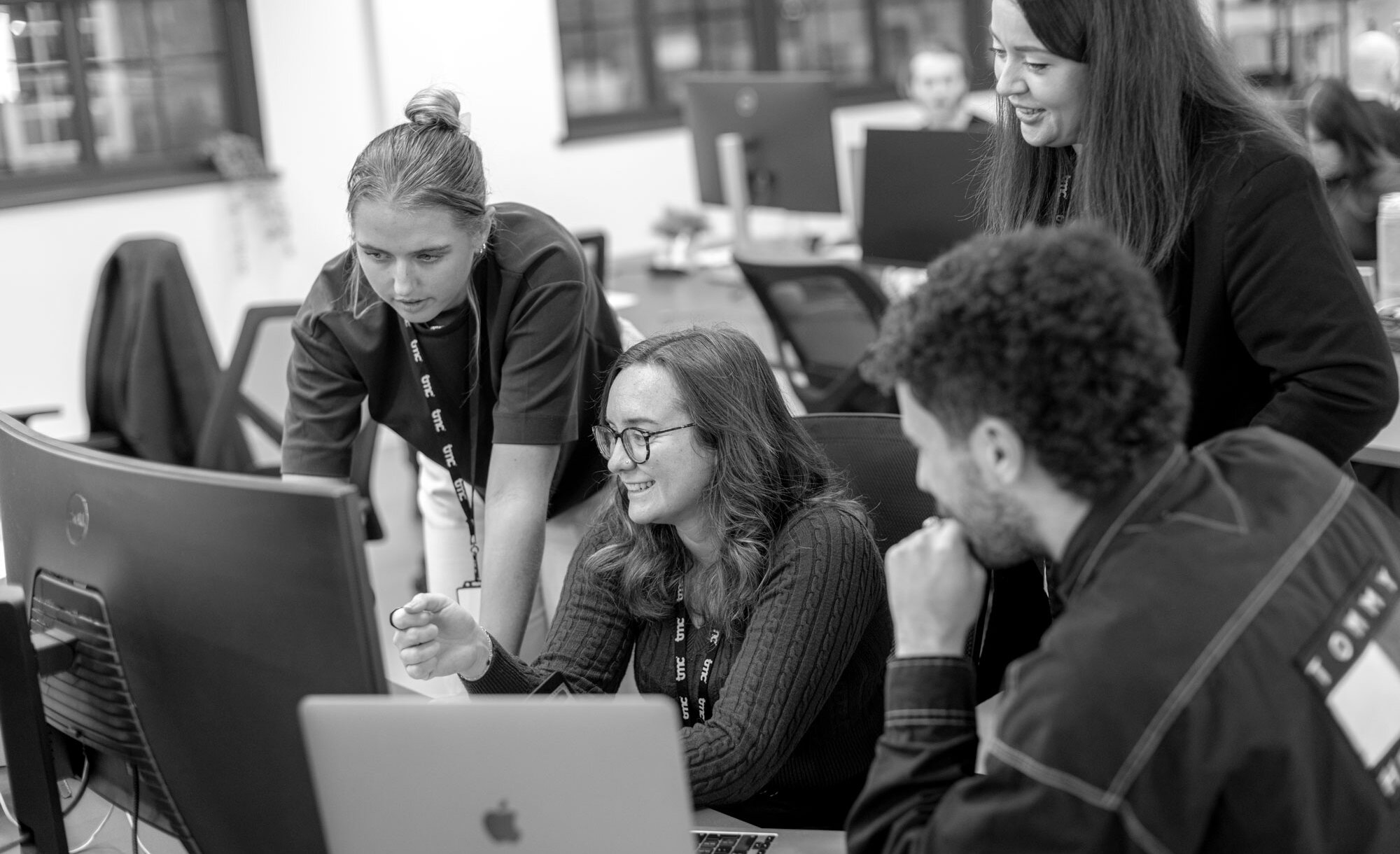 Group of people at a desk looking at a computer screen