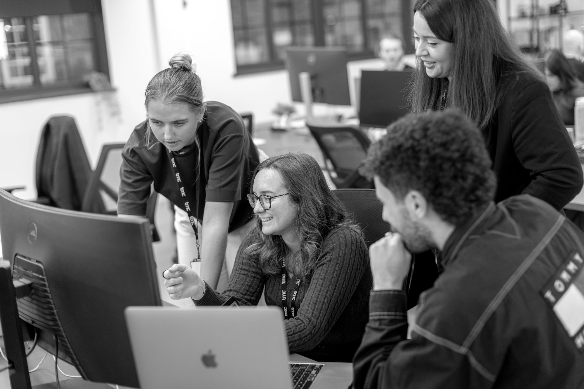 Group of people at a desk looking at a computer screen