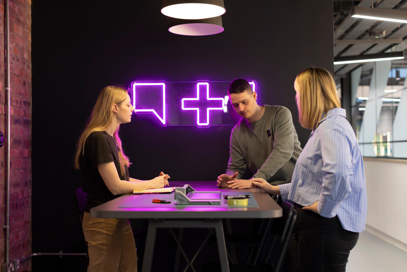 three people at table at TMC office
